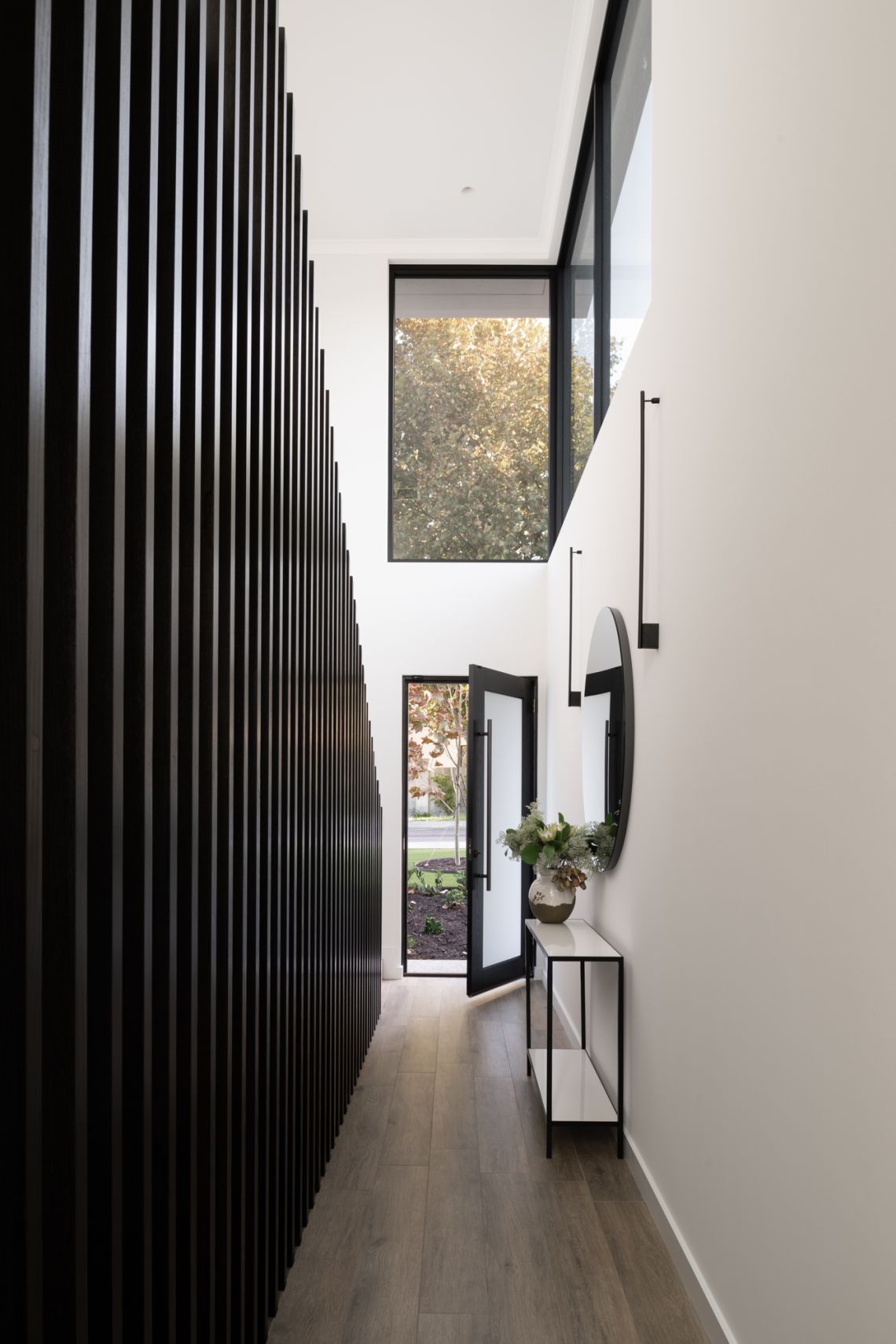 Double height entry hall with black timber battens in Applecross