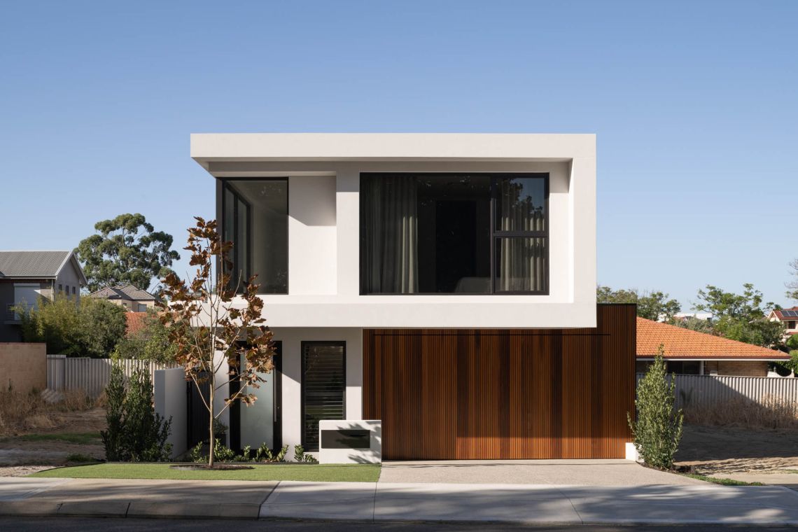 Modern two storey home with cantilevered upper floor and timber garage door in Applecross