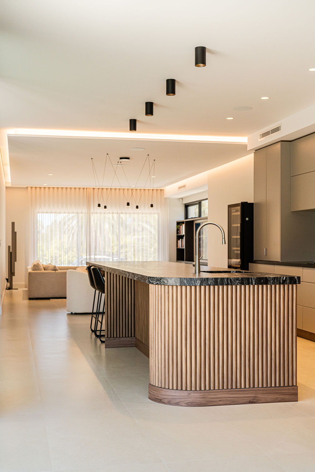 Kitchen with fluted timber island and dark stone benchtop in Kallaroo