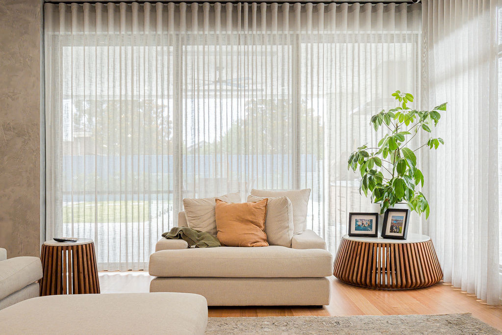 Living room with sheer curtains, cream chaise and timber side tables in Attadale