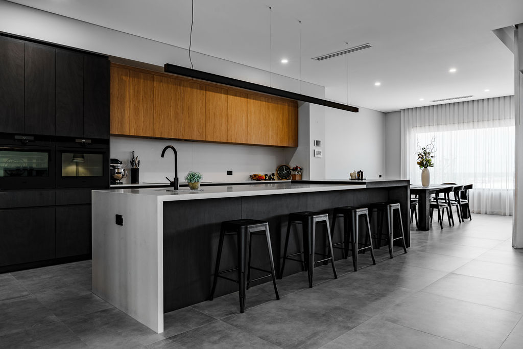 Kitchen with black cabinetry, timber overheads and long island bench