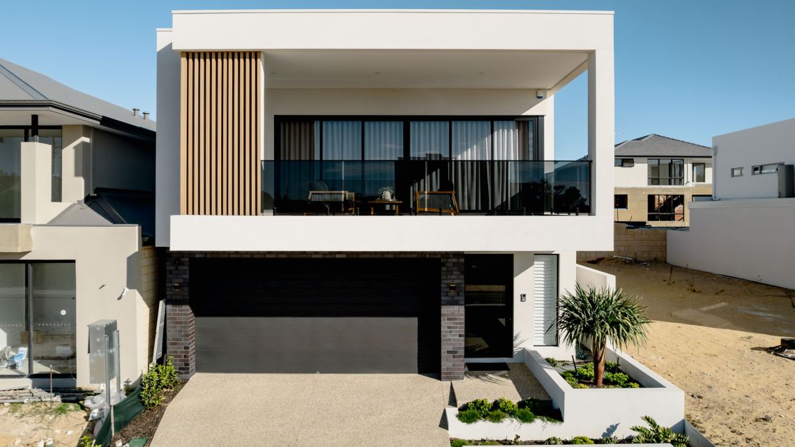 Two storey home with timber screen and glass balcony in North Coogee
