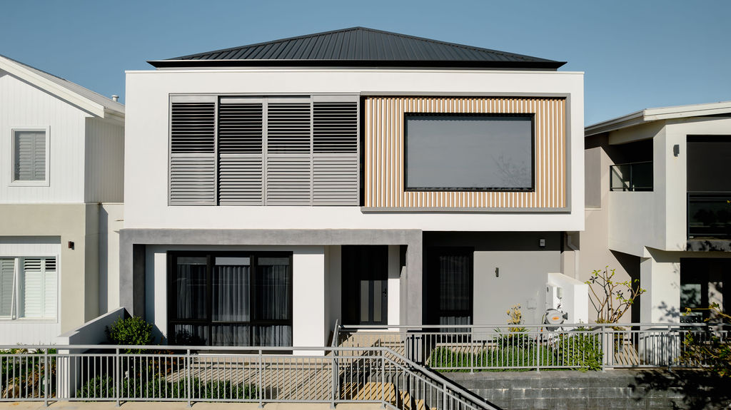 Two storey home with timber batten feature and louvred shutters in North Coogee