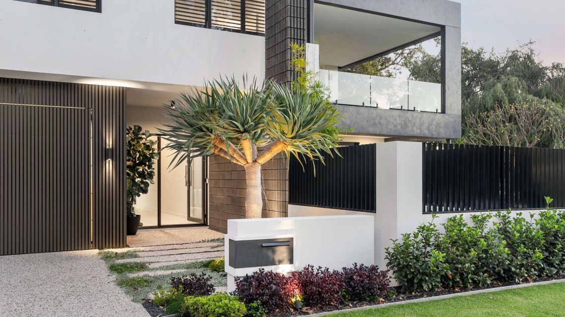Modern two storey home entry with dragon tree and timber screening in Attadale