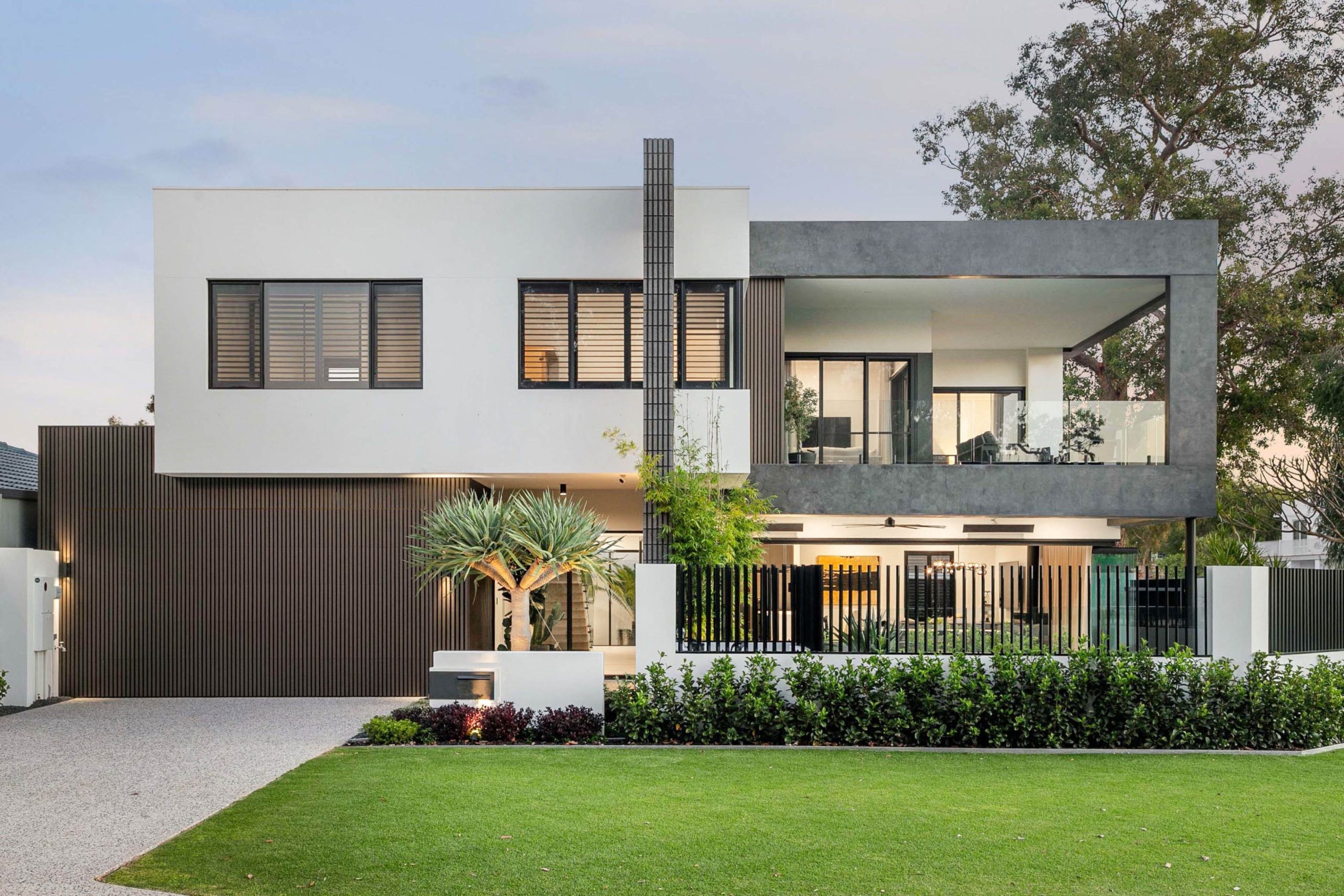 Front facade of a modern two storey home with dragon tree in Attadale