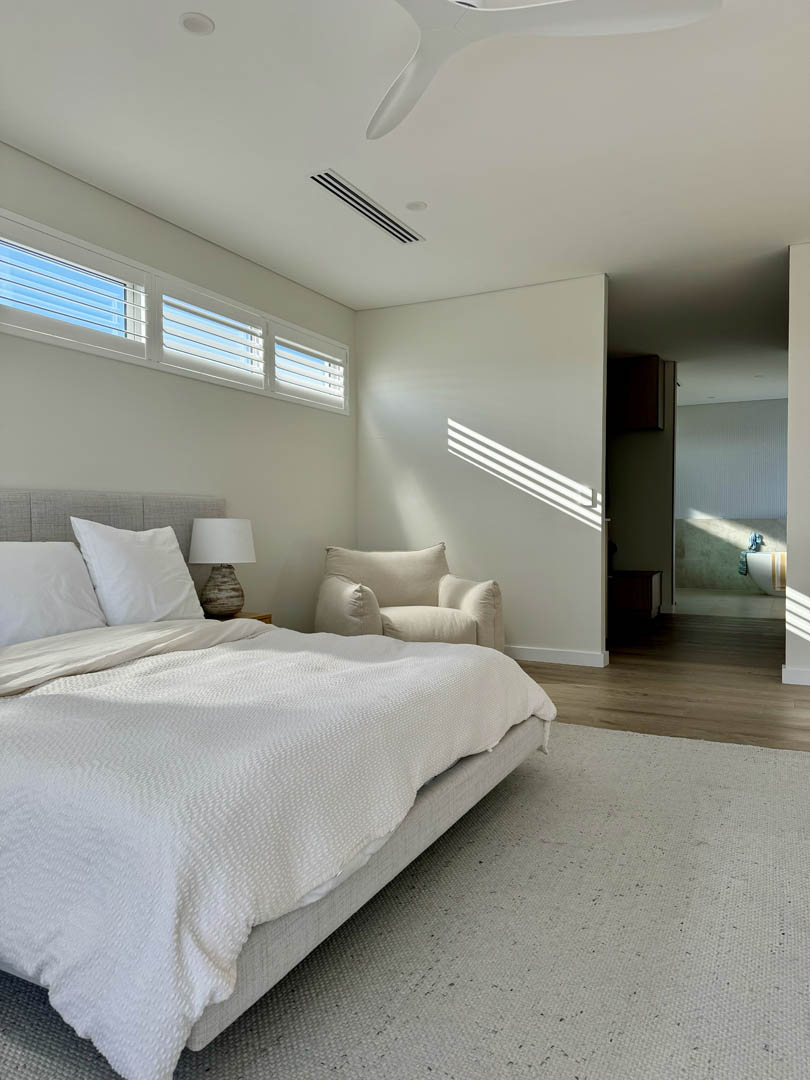 Main bedroom with plantation shutters and ensuite beyond in City Beach