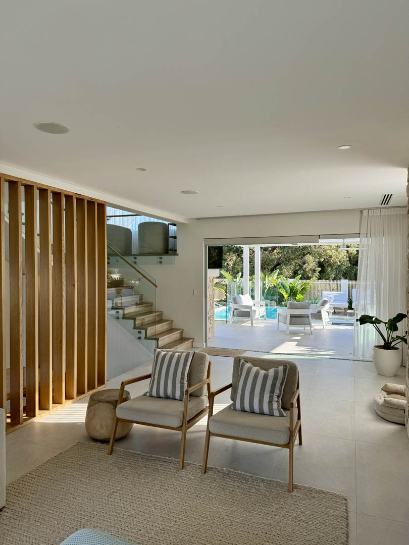 Living room with timber battens and staircase opening to the pool in City Beach