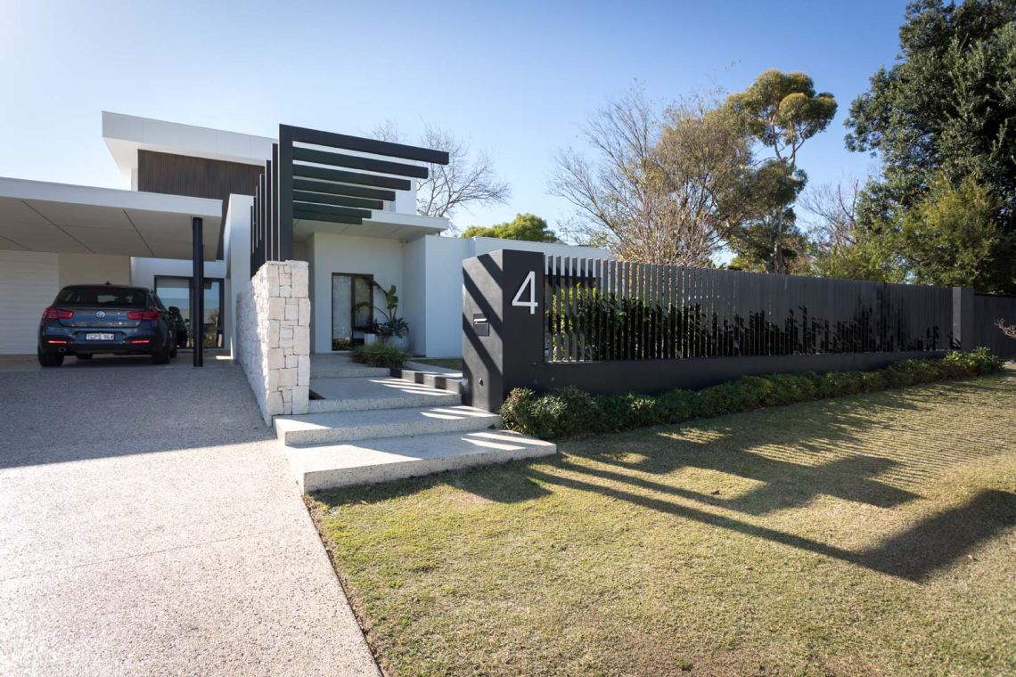 Front steps and slatted fence of a modern single storey home in Floreat