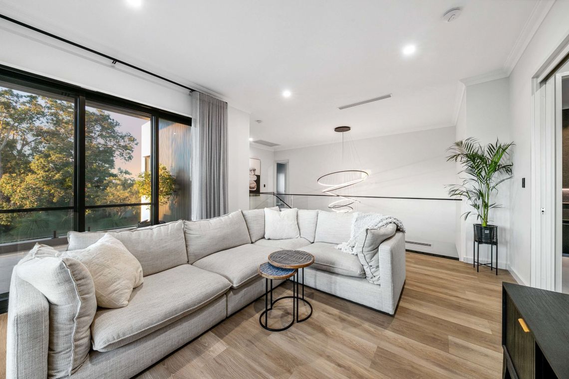 Upstairs lounge with sectional sofa and ring pendant light in Attadale