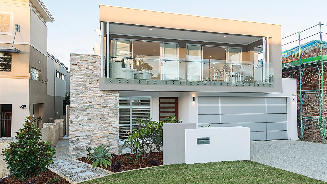 Two storey home with glass balcony and stacked stone wall in Ardross
