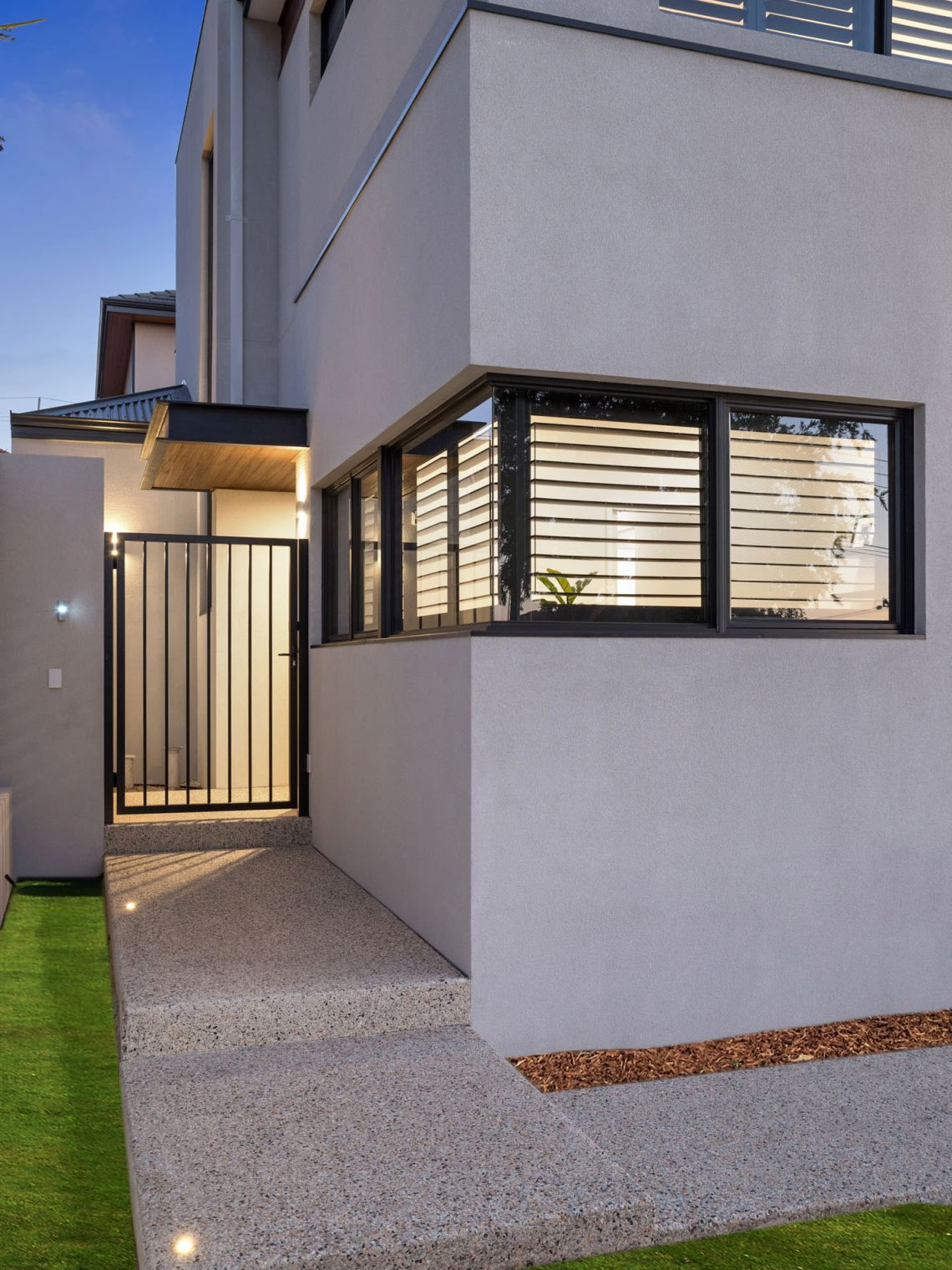 Side entry path and gate beside a rendered home at dusk in Tuart Hill