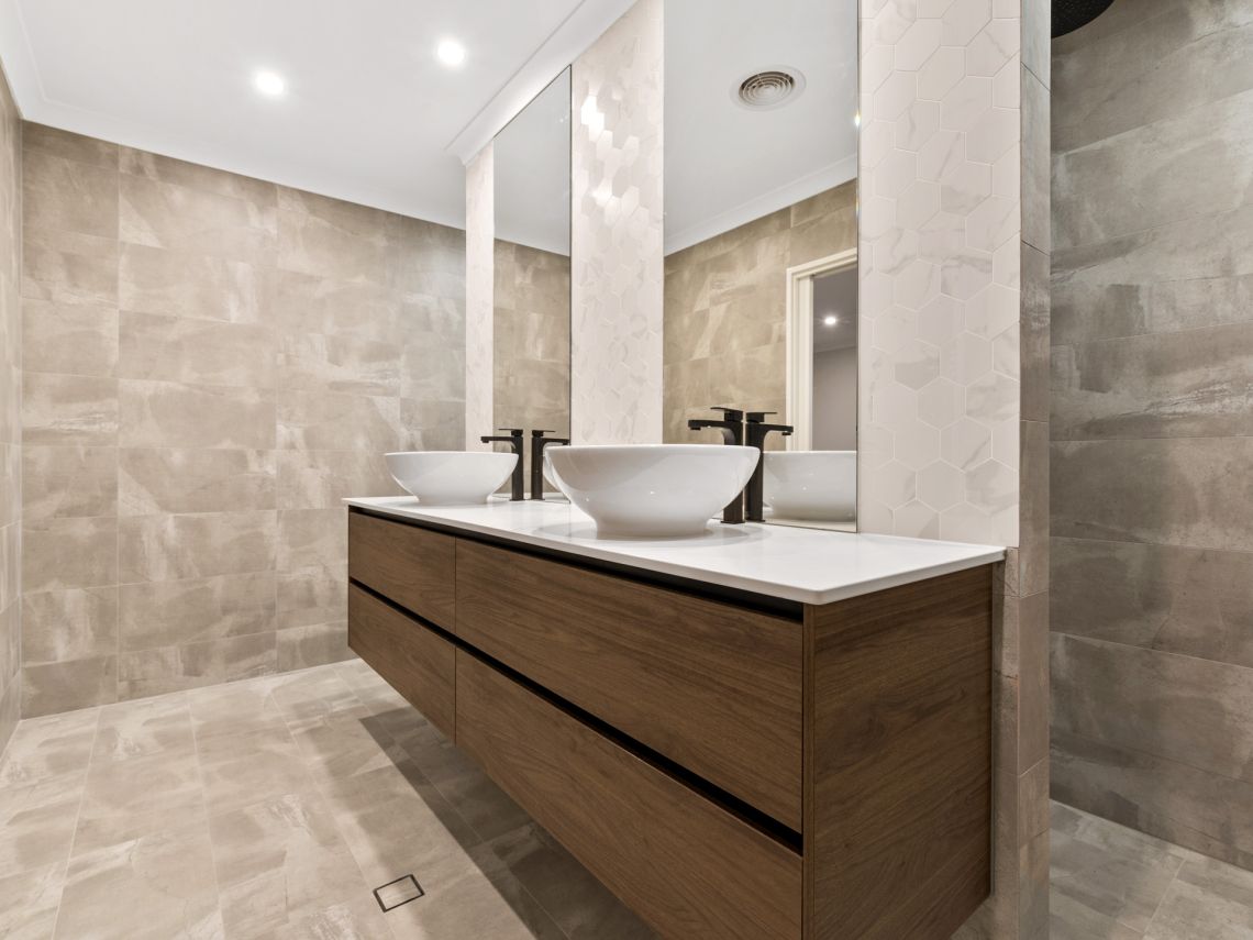 Ensuite with timber vanity and twin vessel basins in Tuart Hill